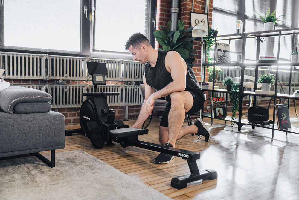 man setting up foldable rowing machine